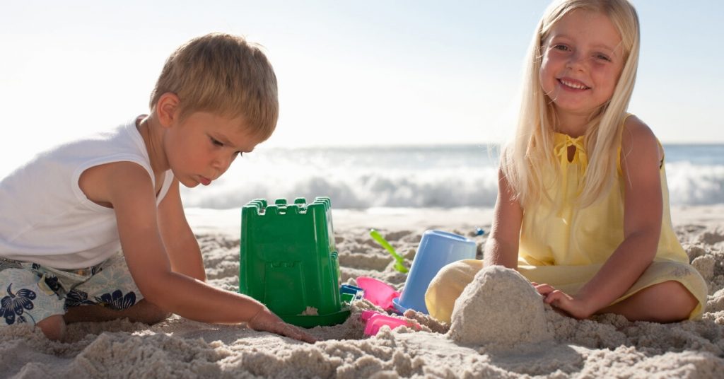 kids making sand castles on the beach